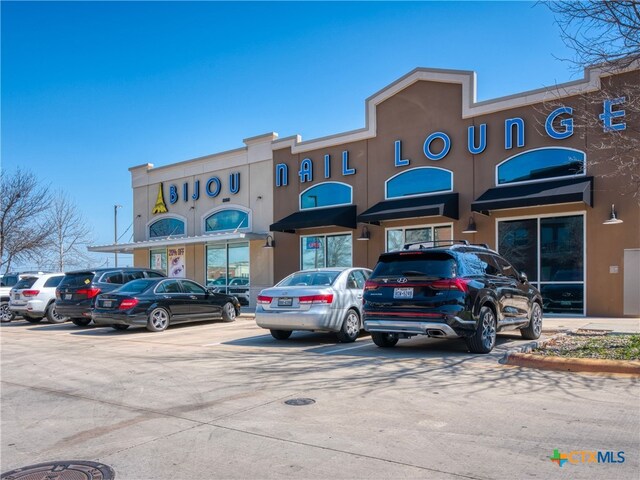 view of property featuring uncovered parking