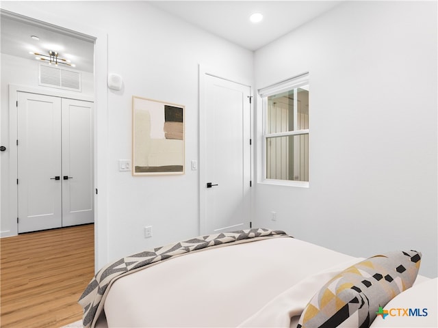 bedroom featuring recessed lighting and wood finished floors