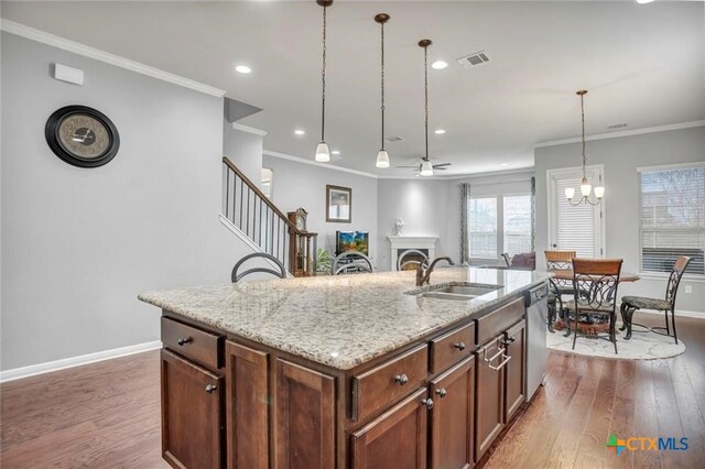 1400 Little Elm Trl Unit 1215, Cedar Park, TX 78613 - kitchen featuring ornamental molding, dishwasher, dark wood finished floors, hanging light fixtures, and light stone counters