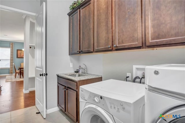1400 Little Elm Trl Unit 1215, Cedar Park, TX 78613 - washroom with washer and dryer, cabinet space, and light tile patterned flooring