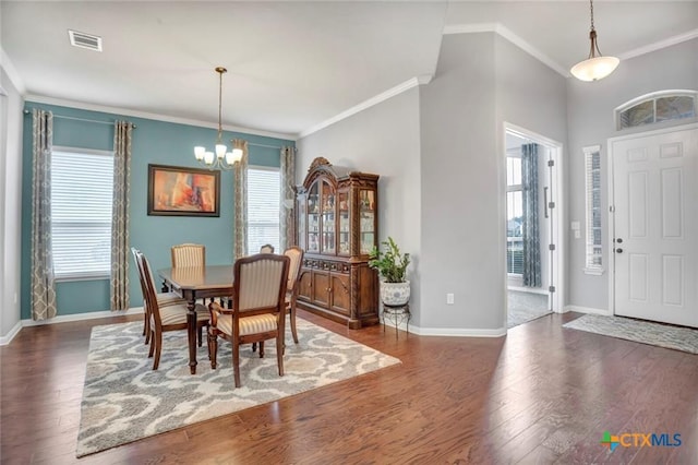1400 Little Elm Trl Unit 1215, Cedar Park, TX 78613 - dining space featuring a chandelier, crown molding, and wood finished floors