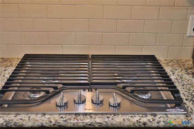 1400 Little Elm Trl Unit 1215, Cedar Park, TX 78613 - kitchen view of tasteful backsplash, stainless steel gas cooktop, and light stone countertops