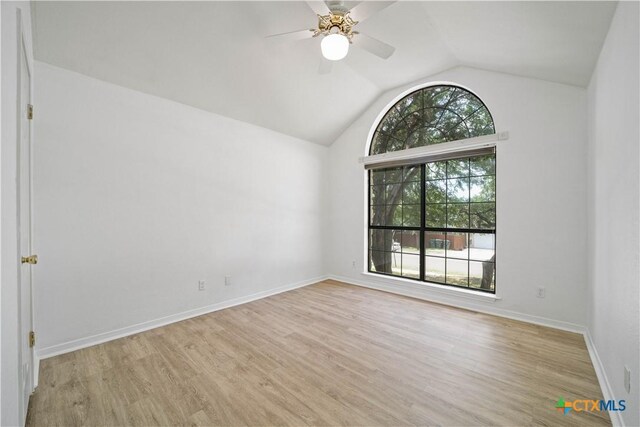 2203 Lancaster St, San Marcos, TX 78666 - unfurnished room with vaulted ceiling, a ceiling fan, light wood-type flooring, and baseboards
