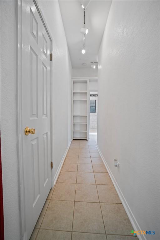 2203 Lancaster St, San Marcos, TX 78666 - hallway featuring light tile patterned flooring and baseboards
