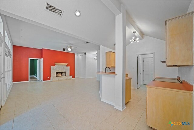 2203 Lancaster St, San Marcos, TX 78666 - kitchen featuring ceiling fan, a stone fireplace, baseboards, and a chandelier