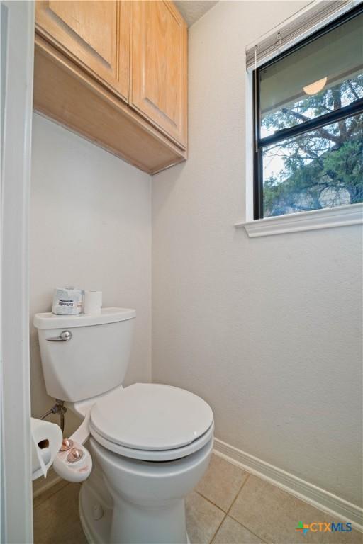 2203 Lancaster St, San Marcos, TX 78666 - bathroom with toilet, baseboards, and tile patterned floors