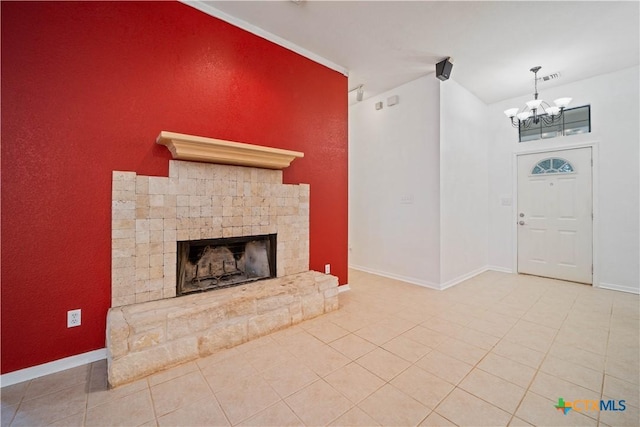 2203 Lancaster St, San Marcos, TX 78666 - unfurnished living room featuring a chandelier, baseboards, a fireplace with raised hearth, and light tile patterned floors