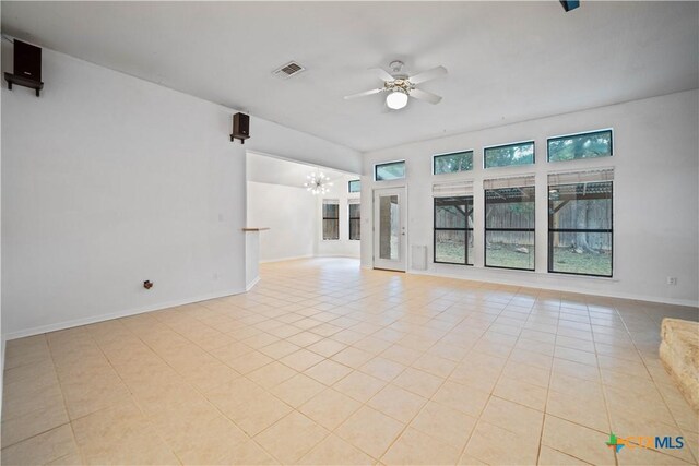 2203 Lancaster St, San Marcos, TX 78666 - unfurnished living room with a chandelier, ceiling fan, tile patterned floors, and baseboards