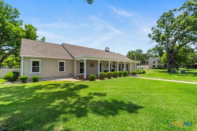 707 W Thompson Ave, Temple, TX 76501 - ranch-style house with a front lawn, brick siding, and roof with shingles