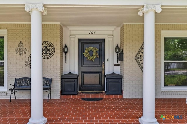 707 W Thompson Ave, Temple, TX 76501 - doorway to property with covered porch and brick siding