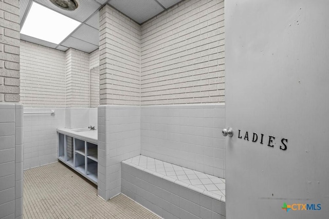 707 W Thompson Ave, Temple, TX 76501 - full bathroom featuring wainscoting, tile patterned flooring, vanity, and pet washing station