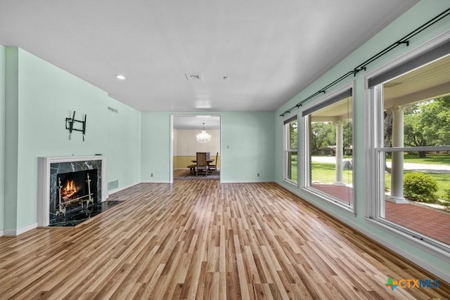 707 W Thompson Ave, Temple, TX 76501 - unfurnished living room featuring wood finished floors, healthy amount of natural light, baseboards, and recessed lighting