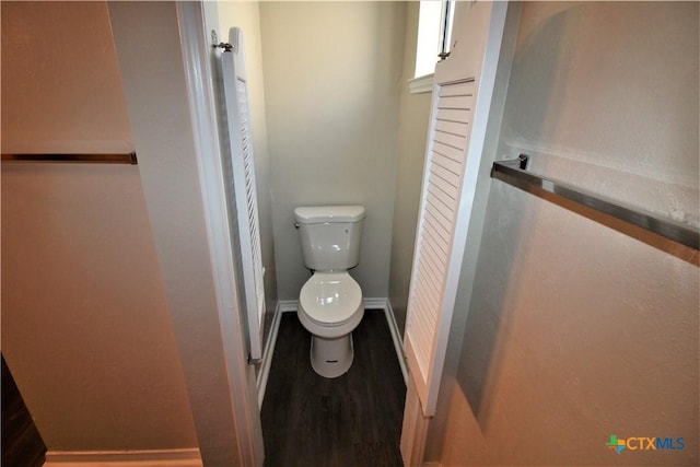 bathroom with hardwood / wood-style flooring and toilet