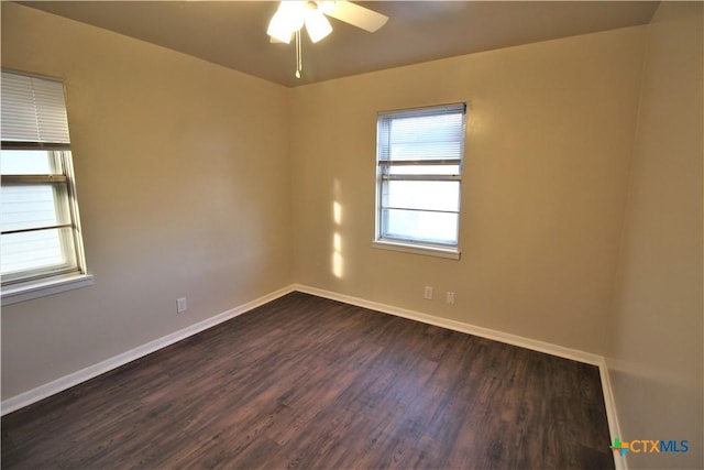 unfurnished room with ceiling fan and dark wood-type flooring