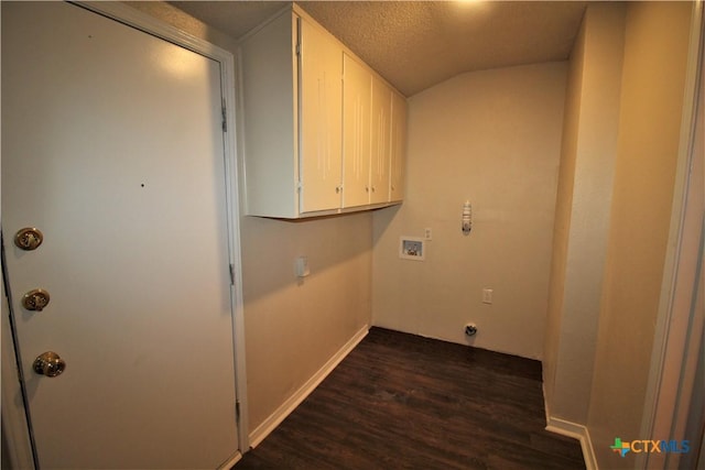 laundry area with dark hardwood / wood-style floors, hookup for a washing machine, cabinets, and a textured ceiling