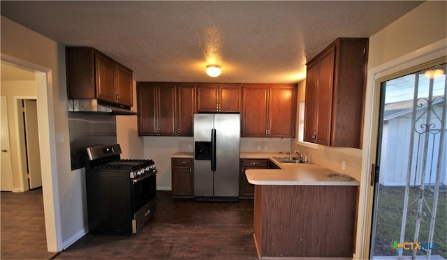 kitchen featuring black gas range, sink, dark wood-type flooring, stainless steel refrigerator with ice dispenser, and a textured ceiling