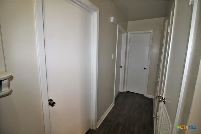 corridor with dark hardwood / wood-style floors