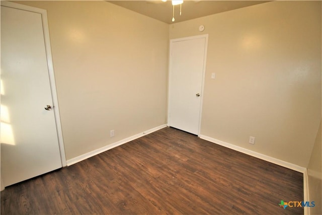 empty room with dark hardwood / wood-style flooring