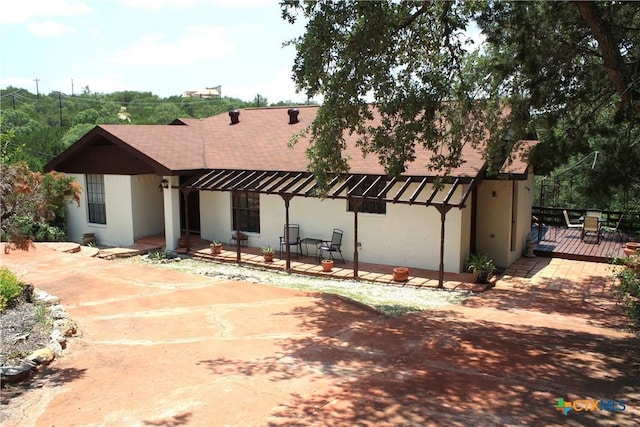 1004 Daviot Dr, Briarcliff, TX 78669 - rear view of property featuring roof with shingles, a deck, stucco siding, and a patio