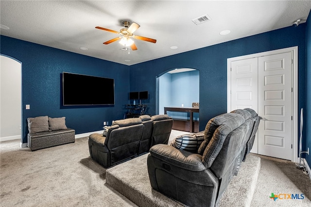 cinema room featuring carpet and ceiling fan