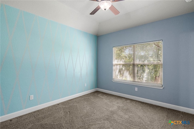 unfurnished room with carpet, ceiling fan, and vaulted ceiling