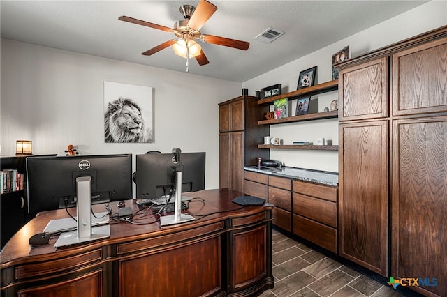 office area with ceiling fan and a textured ceiling