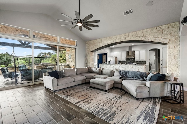 living room with ceiling fan and lofted ceiling