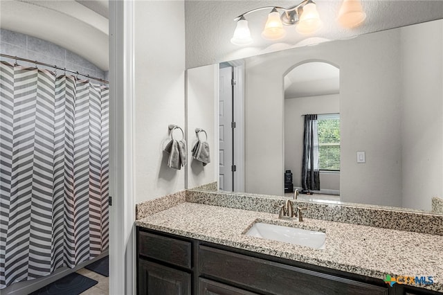 bathroom with curtained shower and vanity