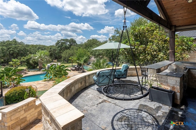 view of patio featuring exterior kitchen