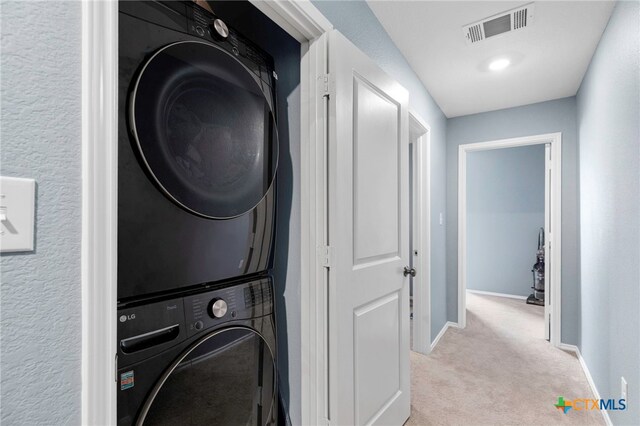 12 Trinity Cir, Lockhart, TX 78644 - laundry room with estacked washer and dryer and light colored carpet