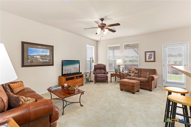 living room with a ceiling fan and light carpet