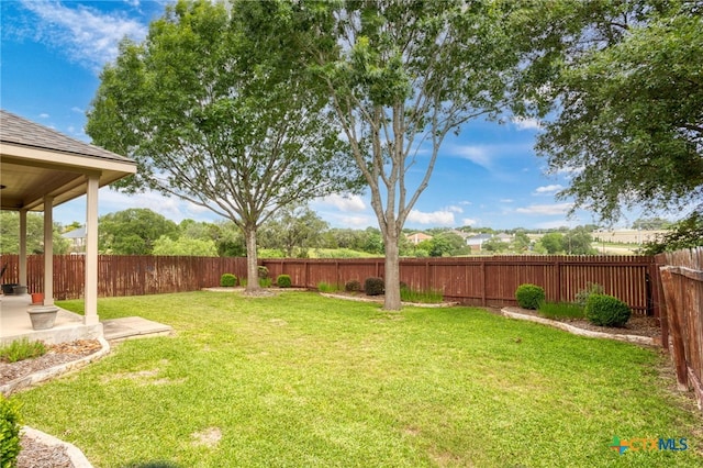 fenced backyard with a patio area