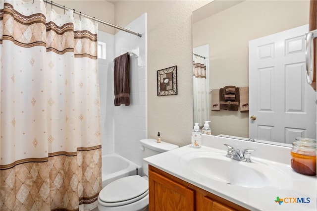 full bathroom with vanity, shower / bath combo with shower curtain, and a textured wall