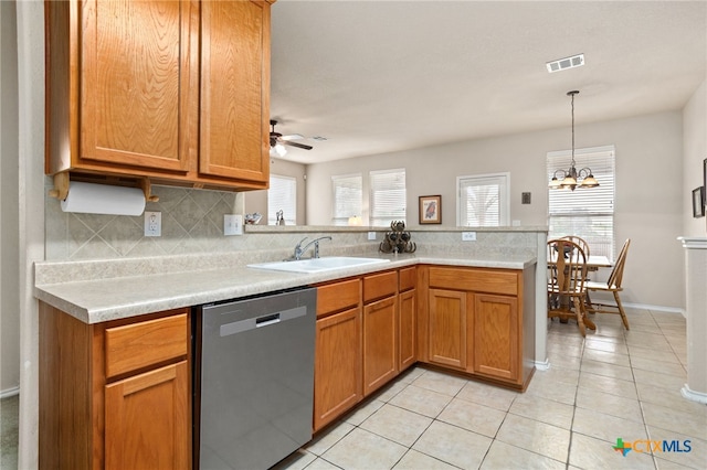 kitchen with dishwasher, tasteful backsplash, a peninsula, light countertops, and light tile patterned flooring