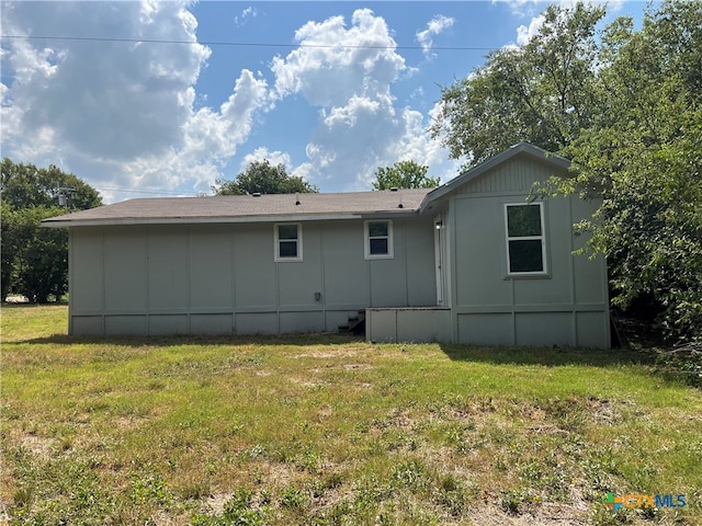 back of house with a yard