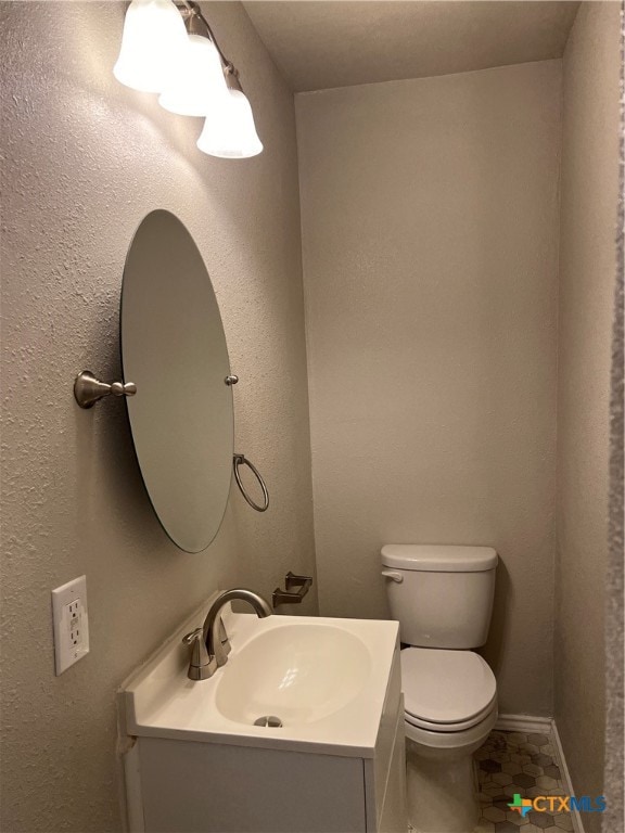 bathroom featuring vanity, tile patterned floors, and toilet