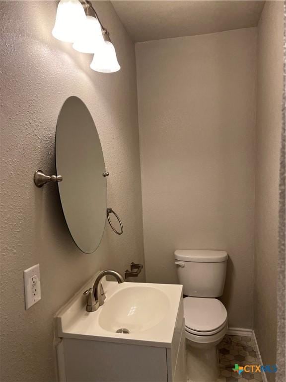 908 S 22nd St, Temple, TX 76501 - half bath featuring toilet, vanity, and baseboards