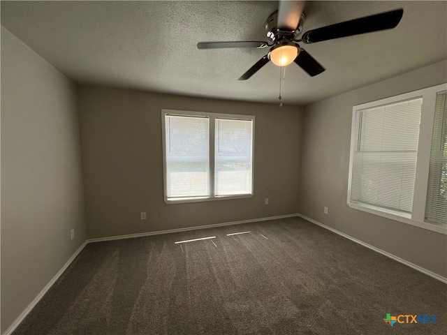 carpeted spare room with a textured ceiling and ceiling fan