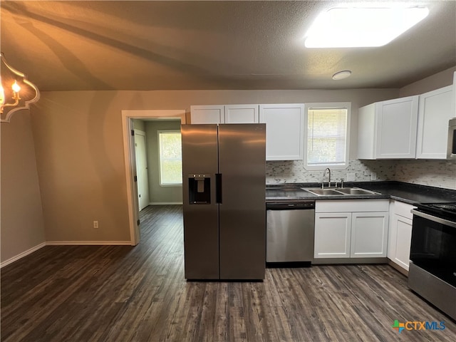 kitchen with stainless steel appliances, decorative backsplash, sink, dark hardwood / wood-style floors, and white cabinetry