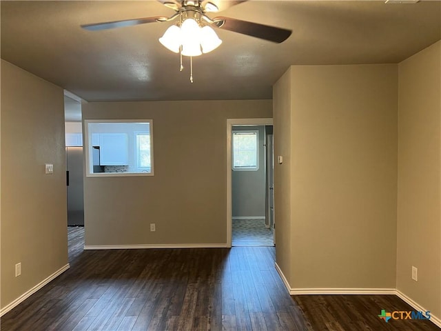 908 S 22nd St, Temple, TX 76501 - spare room with dark wood-type flooring, a ceiling fan, plenty of natural light, and baseboards