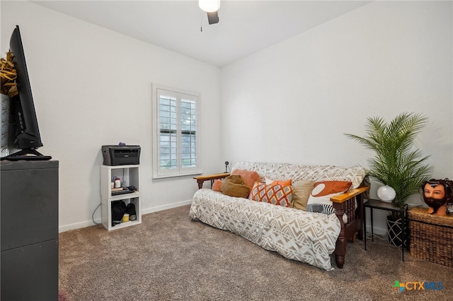 sitting room with ceiling fan and carpet flooring