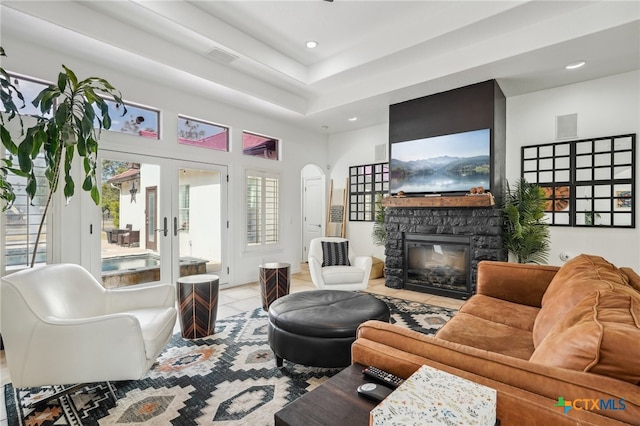 tiled living room with french doors and a fireplace