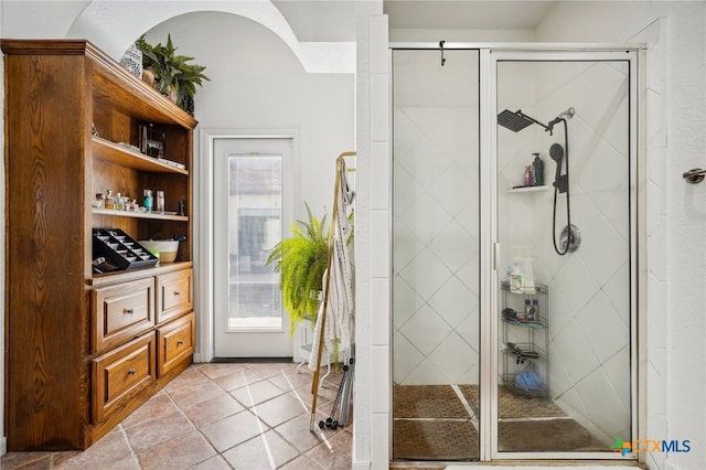 bathroom featuring tile patterned flooring and a shower with shower door