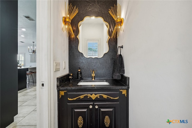 bathroom featuring vanity, tile patterned flooring, and a healthy amount of sunlight