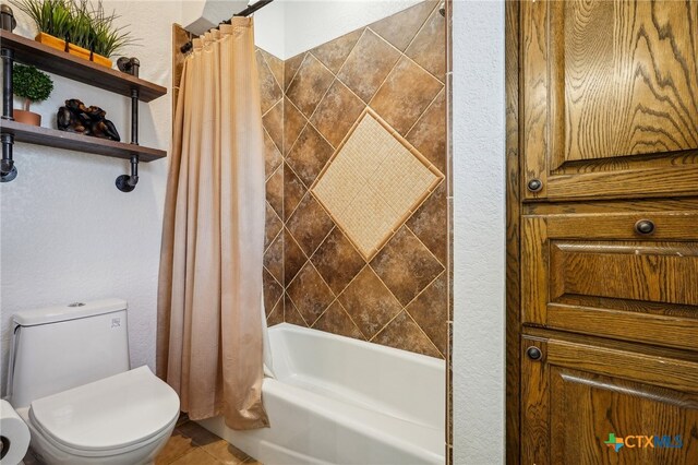 bathroom featuring shower / tub combo with curtain, toilet, and tile patterned flooring