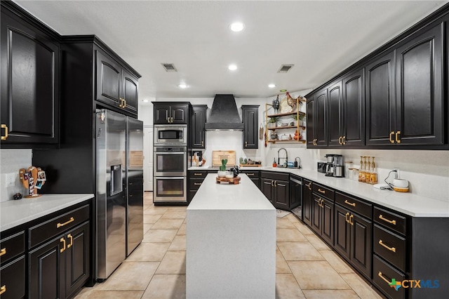 kitchen with a kitchen island, appliances with stainless steel finishes, premium range hood, and light tile patterned flooring