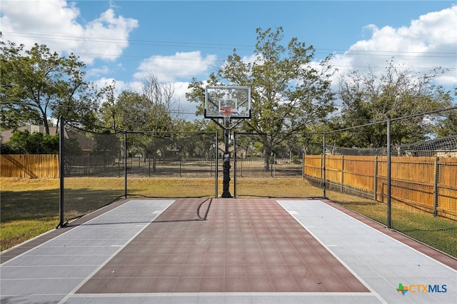 view of basketball court featuring a yard