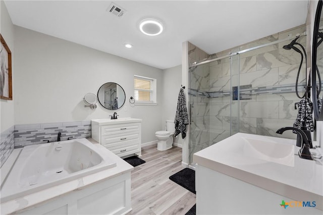 7031 Steinbeck Bend Dr, Waco, TX 76708 - full bathroom with vanity, a jetted tub, a stall shower, recessed lighting, and wood finished floors
