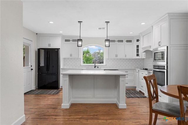 7031 Steinbeck Bend Dr, Waco, TX 76708 - kitchen with appliances with stainless steel finishes, glass insert cabinets, tasteful backsplash, and recessed lighting