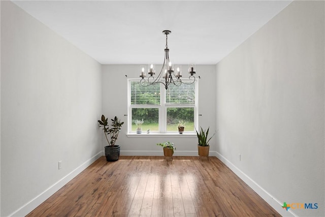 7031 Steinbeck Bend Dr, Waco, TX 76708 - unfurnished room with a chandelier and hardwood / wood-style floors